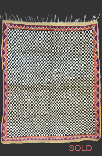 TM 136, highly rare pile-woven Ait Ouaouzguite checker board saddle rug, Jebel Siroua region, southern Morocco, 1920s, 145 x 120 cm (4' 9'' x 3' 11'') ...more